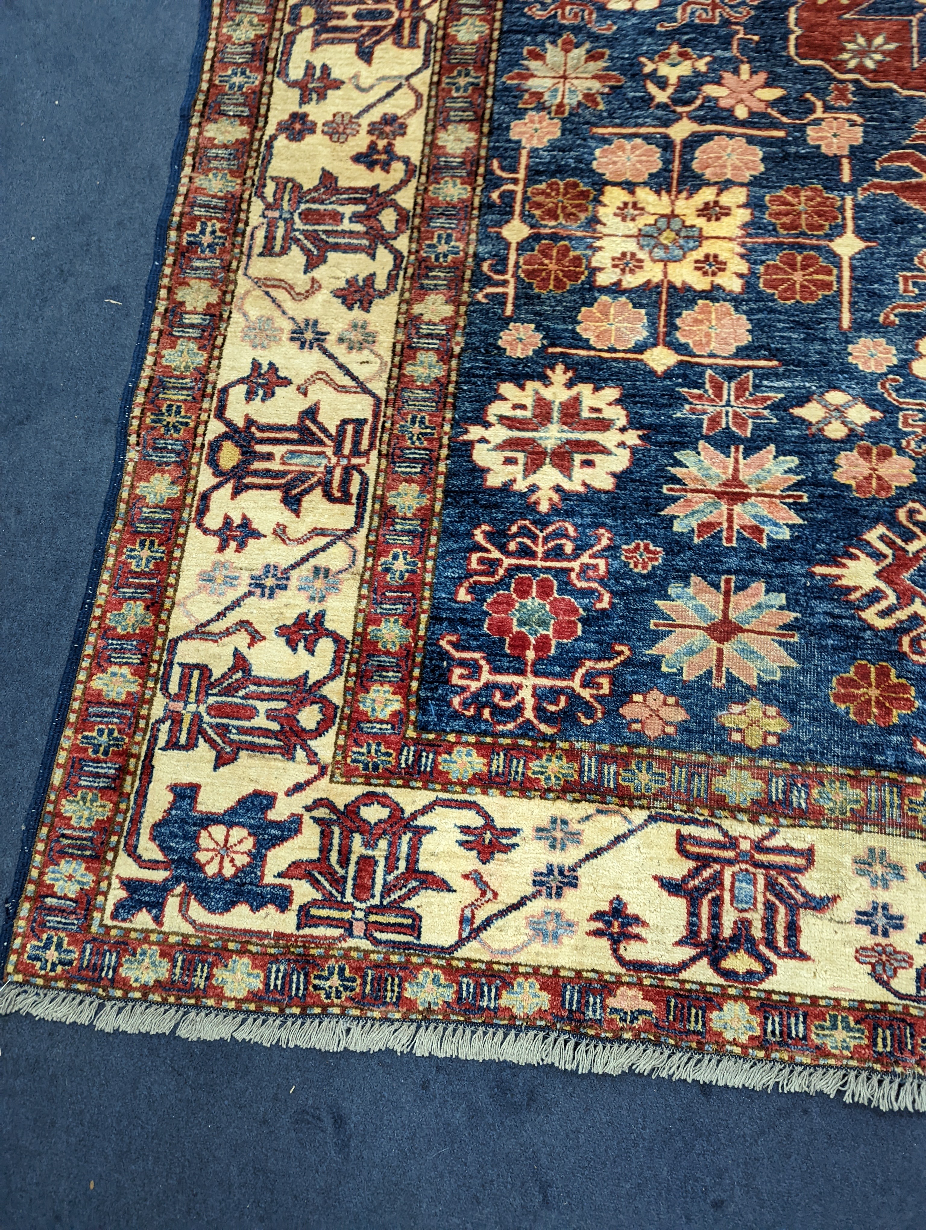 A Kazak blue ground carpet, 242 x 186cm